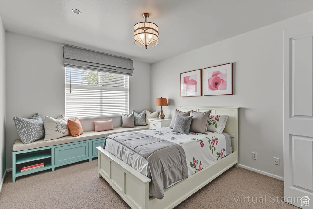 Bedroom with light carpet and baseboards