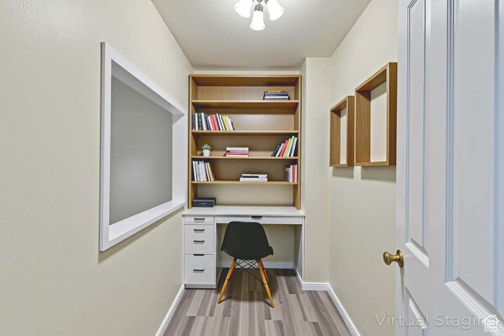 Office space with wood finished floors and built in study area