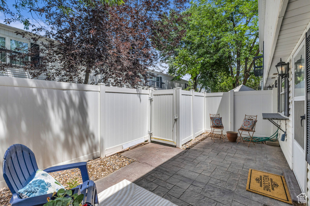 Fenced backyard with a patio area and a gate
