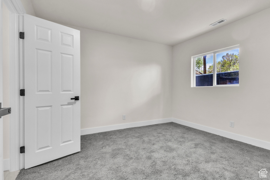 Spare room with carpet floors and baseboards