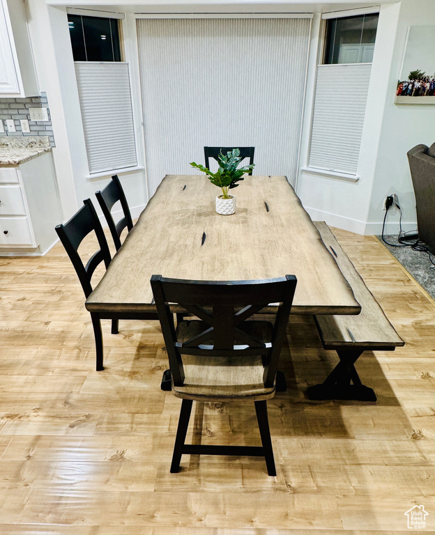 Dining room with light wood finished floors and baseboards