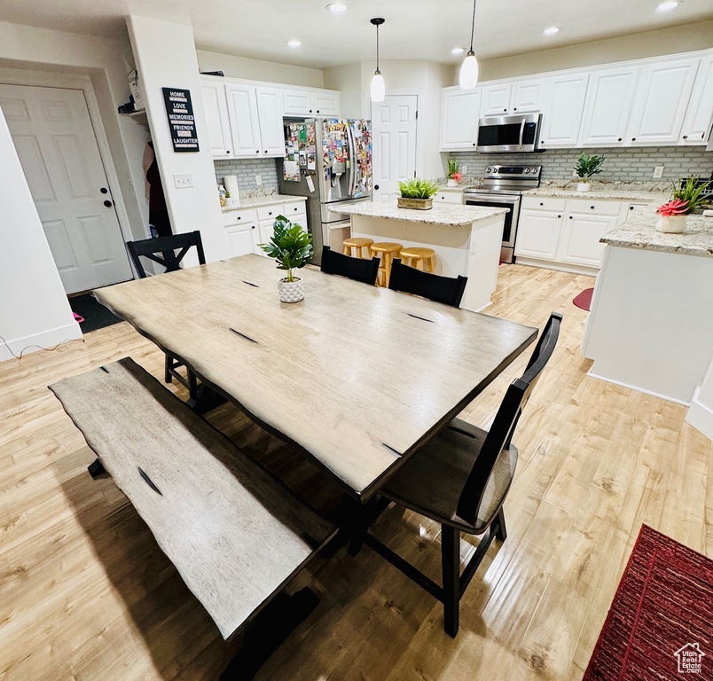 Dining room featuring recessed lighting and light wood-style flooring