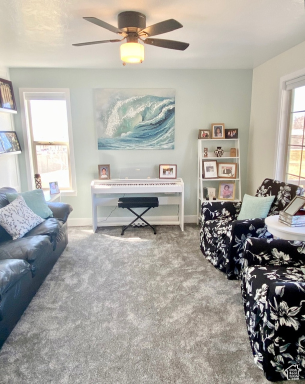 Living area with carpet and a ceiling fan