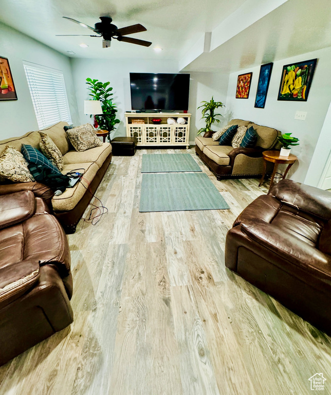 Living area with wood finished floors, a ceiling fan, and recessed lighting