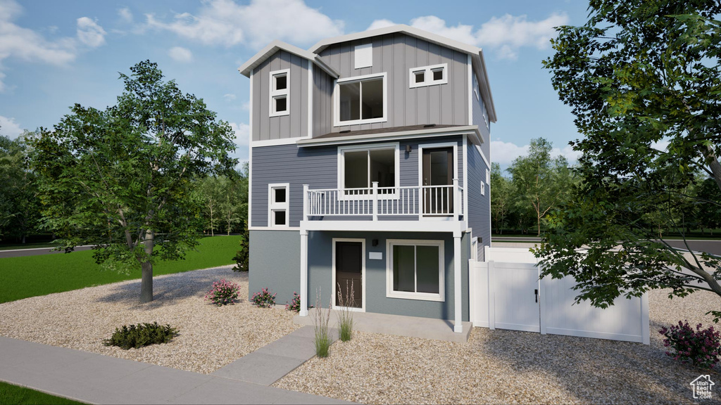 Beach home with board and batten siding and a balcony