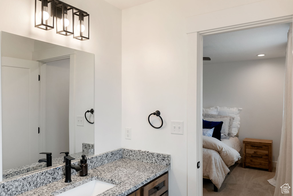 Ensuite bathroom with vanity and recessed lighting