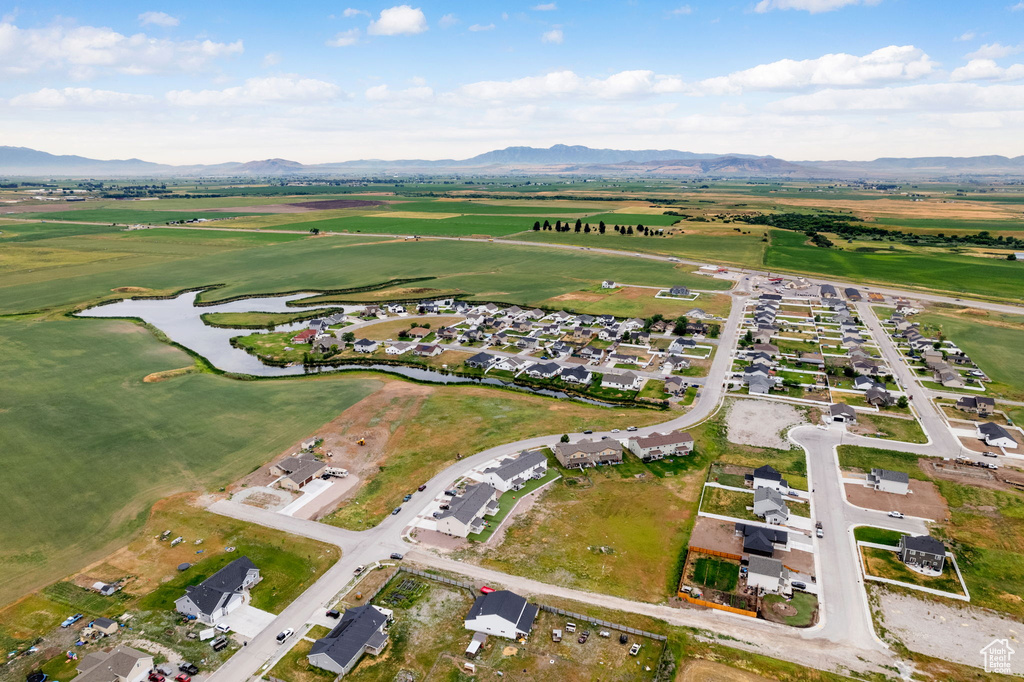 View of property location with a water and mountain view and nearby suburban area