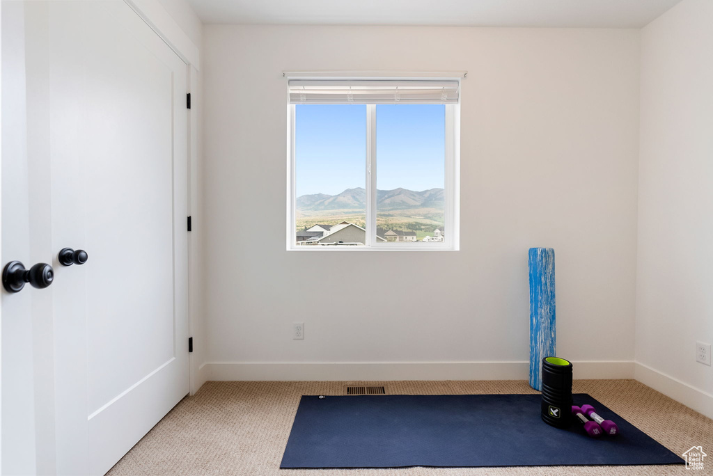 Exercise room featuring carpet flooring and a mountain view