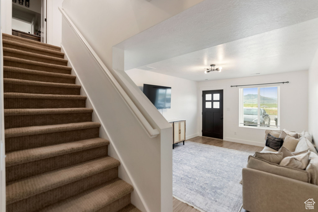 Foyer entrance with stairway and light wood-type flooring