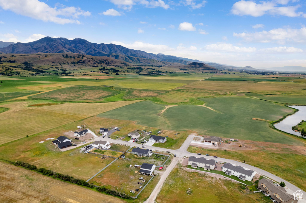 View of property location with mountains, a golf club, and nearby suburban area