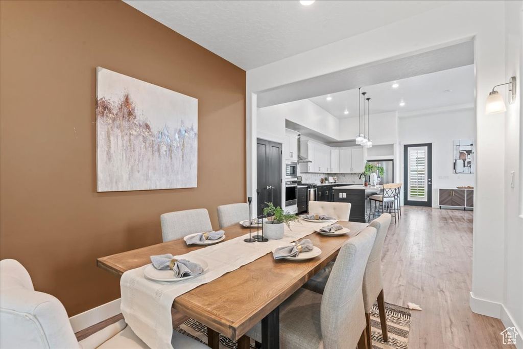 Dining space featuring recessed lighting and light wood finished floors