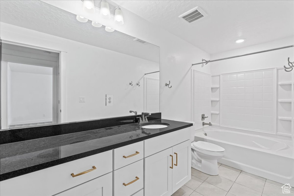 Bathroom with vanity, tile patterned floors, and shower / bath combination