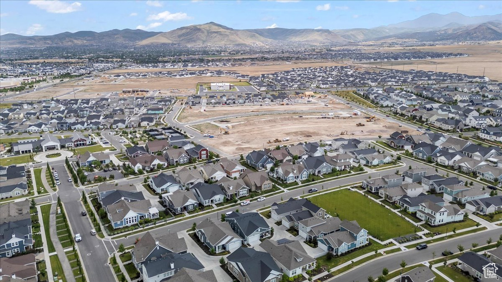 Aerial overview of property's location featuring nearby suburban area and a mountainous background