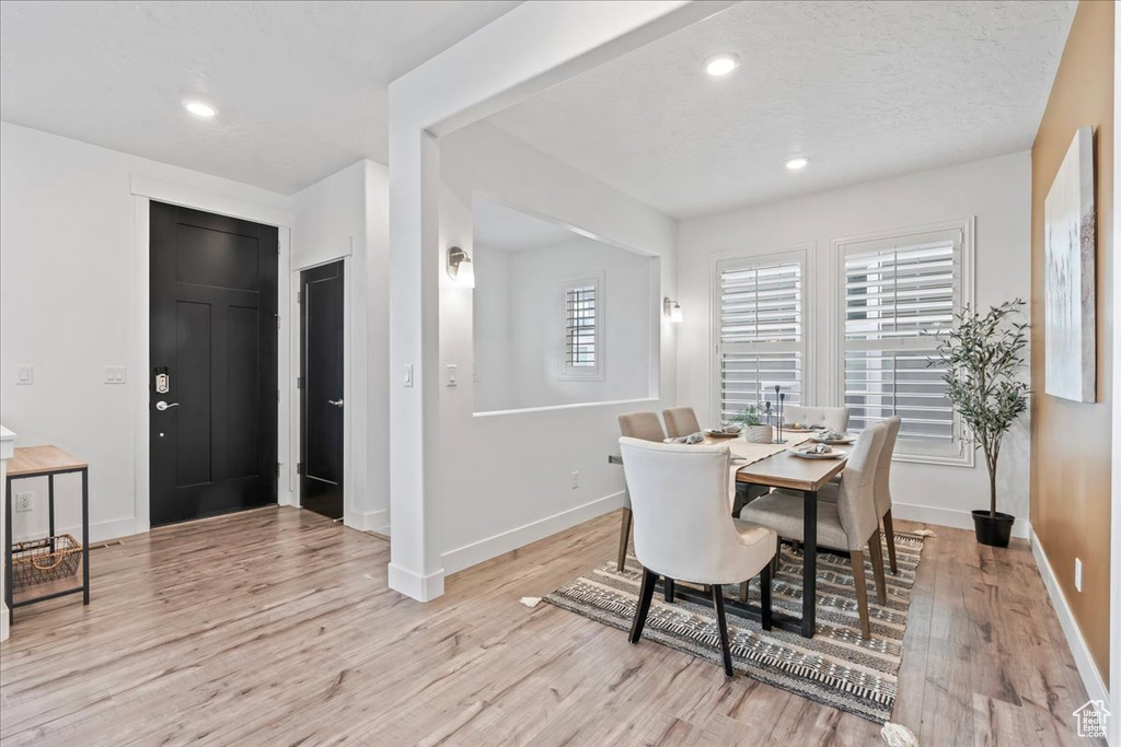 Dining area featuring light wood-type flooring and recessed lighting