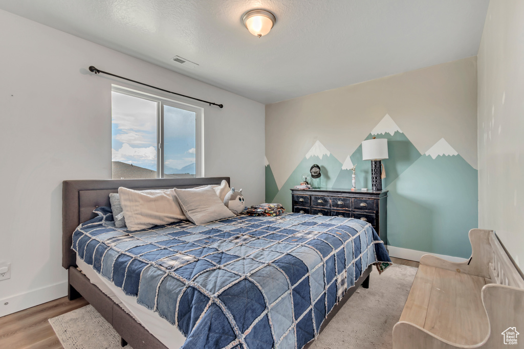 Bedroom featuring baseboards and wood finished floors