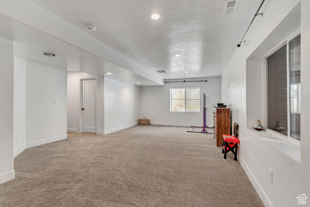 Playroom with light carpet, recessed lighting, and a textured ceiling
