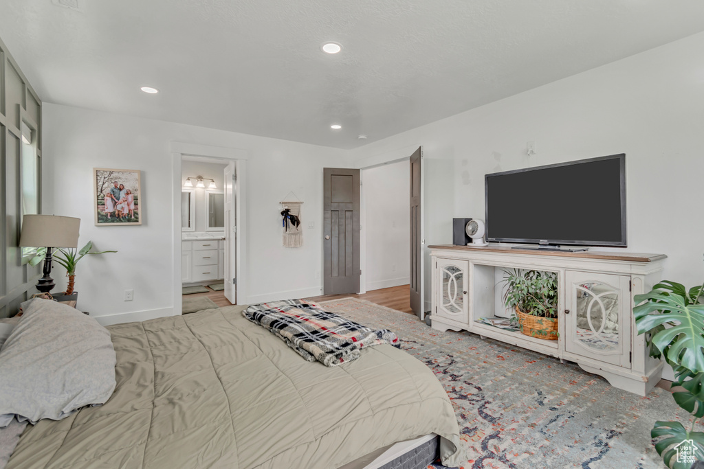 Bedroom featuring recessed lighting and connected bathroom