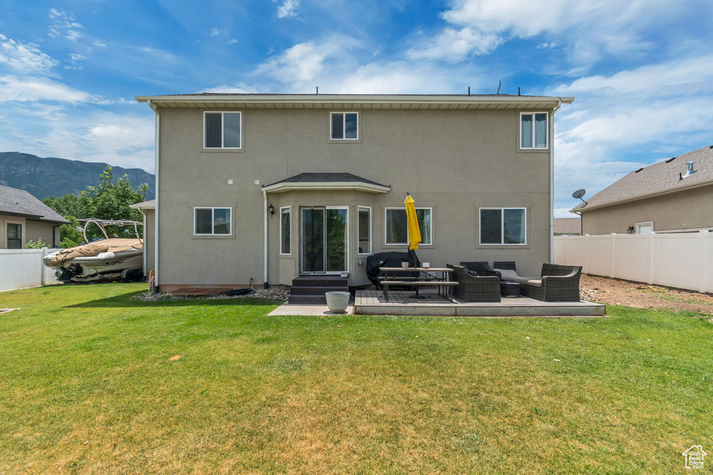 Back of house with an outdoor living space, stucco siding, a mountain view, and entry steps
