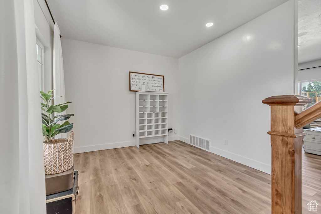 Spare room with light wood-style floors and recessed lighting