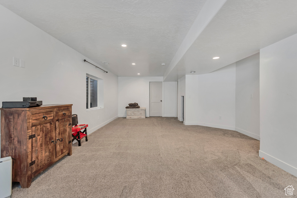 Basement with light carpet and recessed lighting