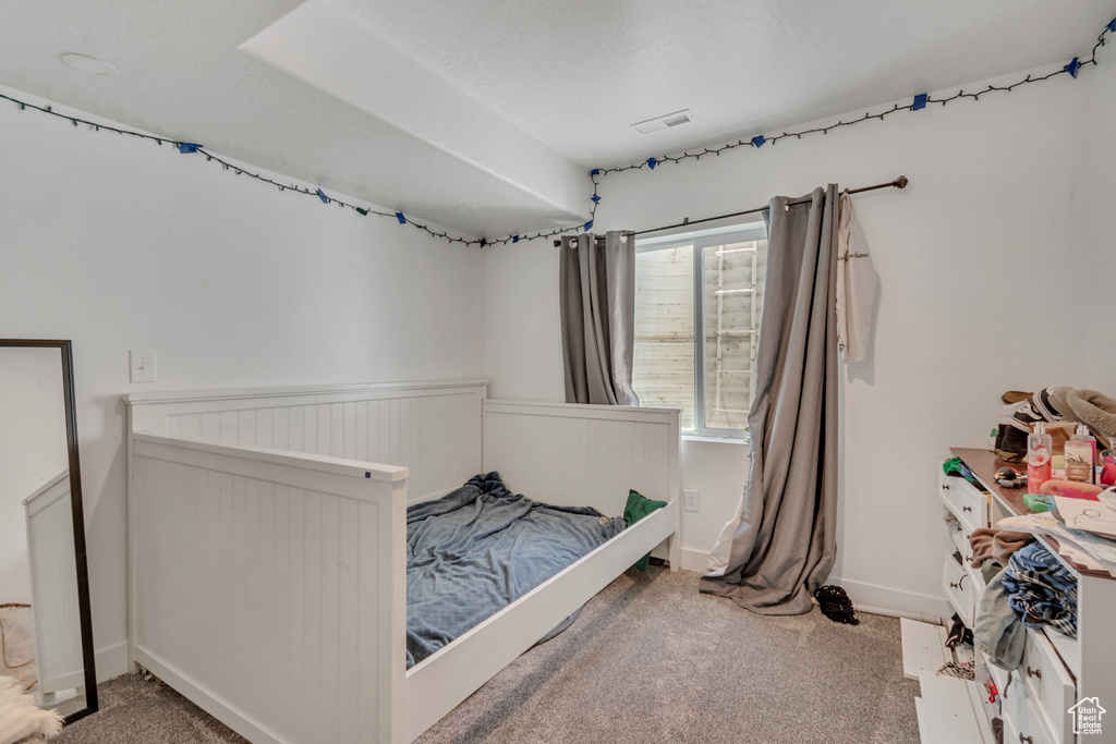 Carpeted bedroom featuring wainscoting and baseboards