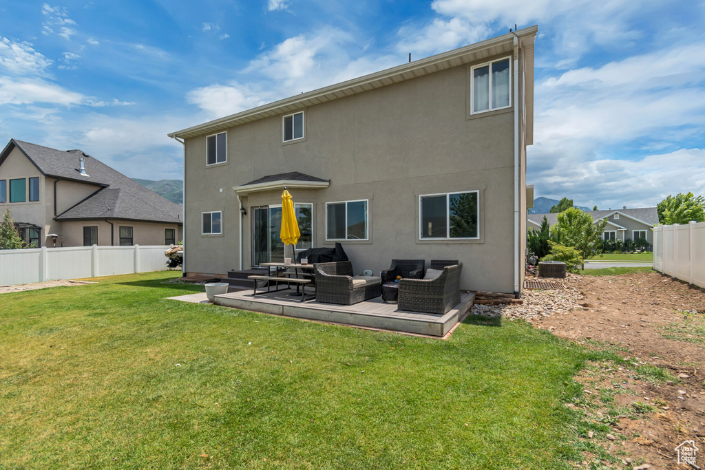 Rear view of property featuring outdoor lounge area, stucco siding, and a patio area