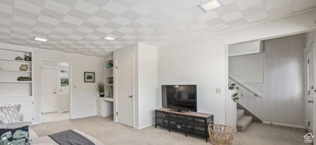 Carpeted living room with stairway
