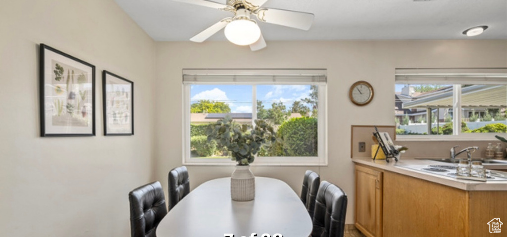 Dining area with ceiling fan and healthy amount of natural light