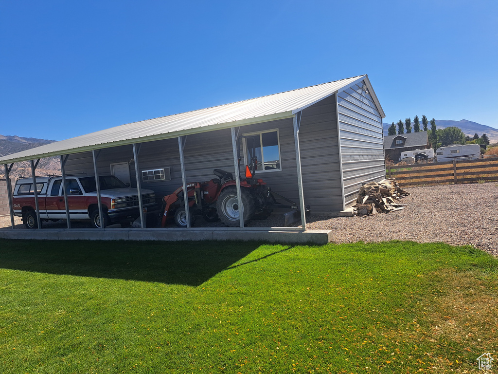 View of outdoor structure with a carport and a mountain view