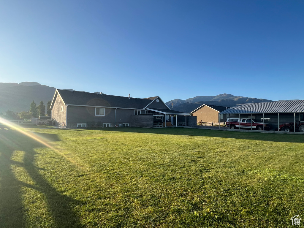 View of green lawn featuring a mountain view