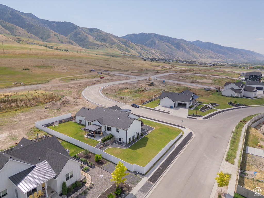 Overview of rural landscape with a mountain backdrop and nearby suburban area