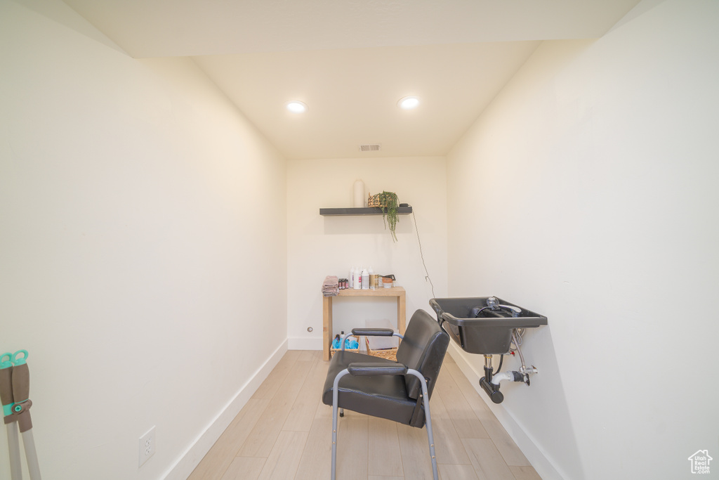 Office with recessed lighting and light wood-style floors