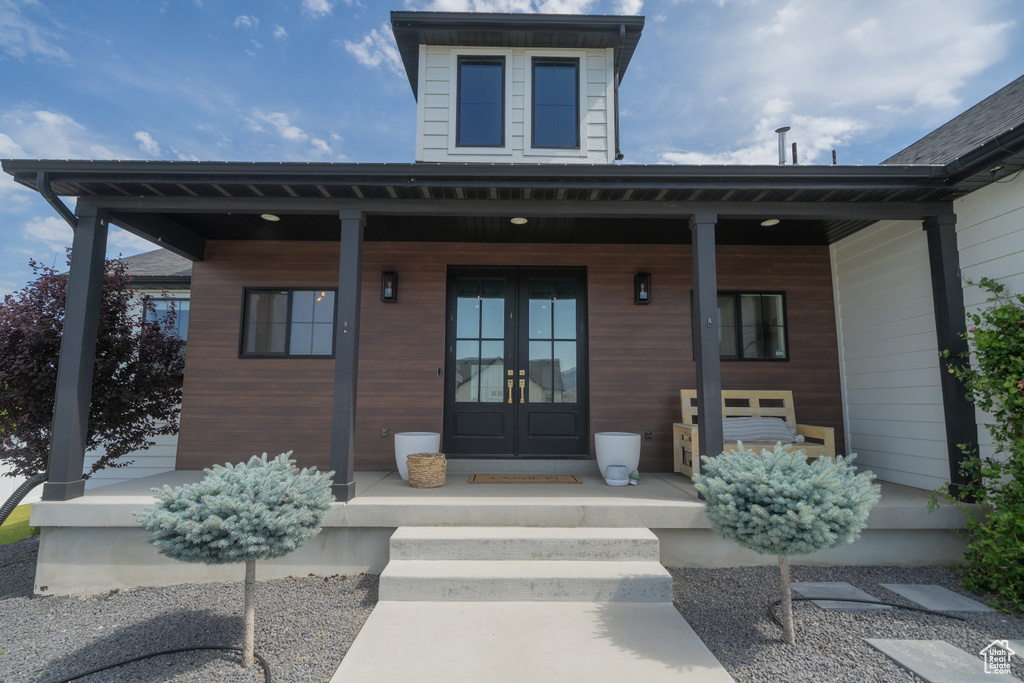 Entrance to property with french doors and covered porch