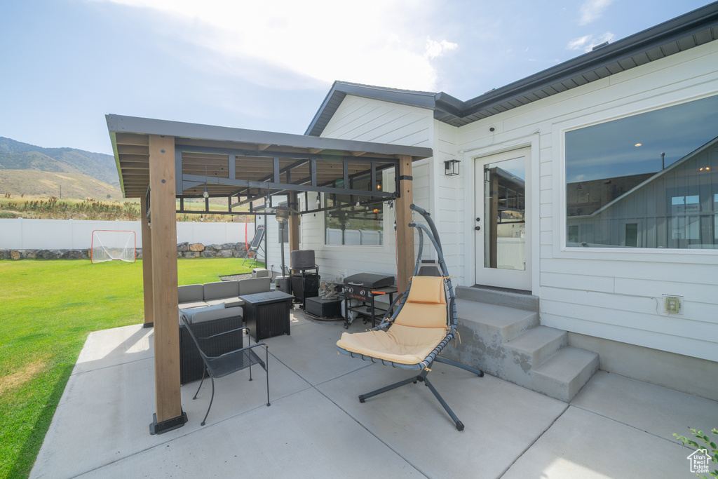 View of patio / terrace with entry steps, an outdoor hangout area, a mountain view, and a grill