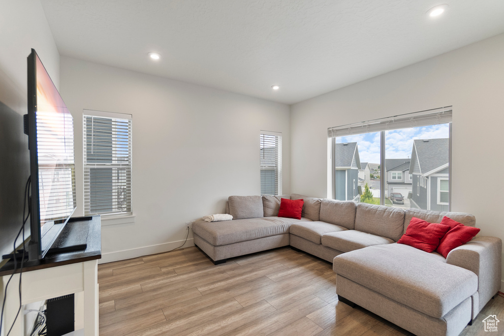 Living room featuring light wood-style flooring and recessed lighting
