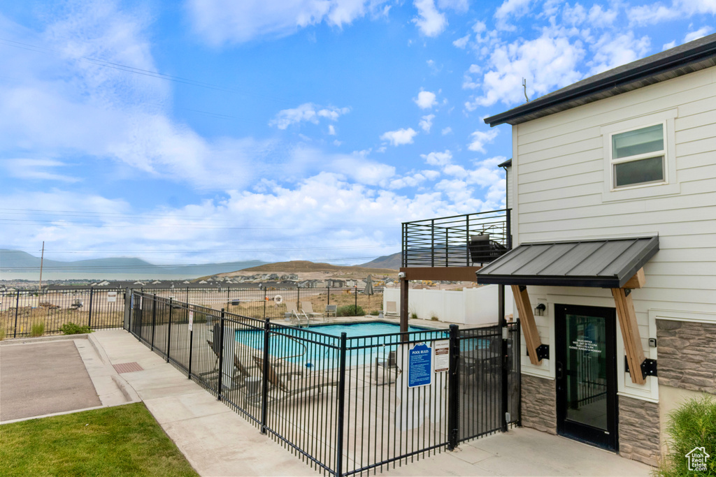 Community pool with a mountain view and a patio area