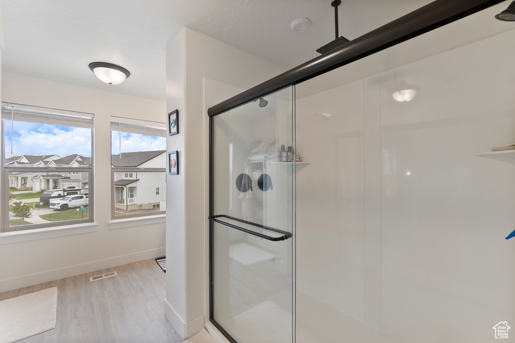 Full bathroom with a stall shower and wood finished floors