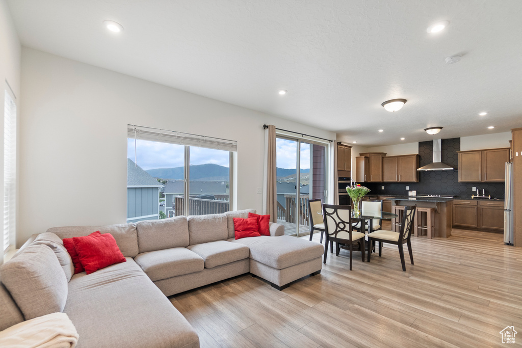 Living room featuring light wood-type flooring, recessed lighting, and a mountain view