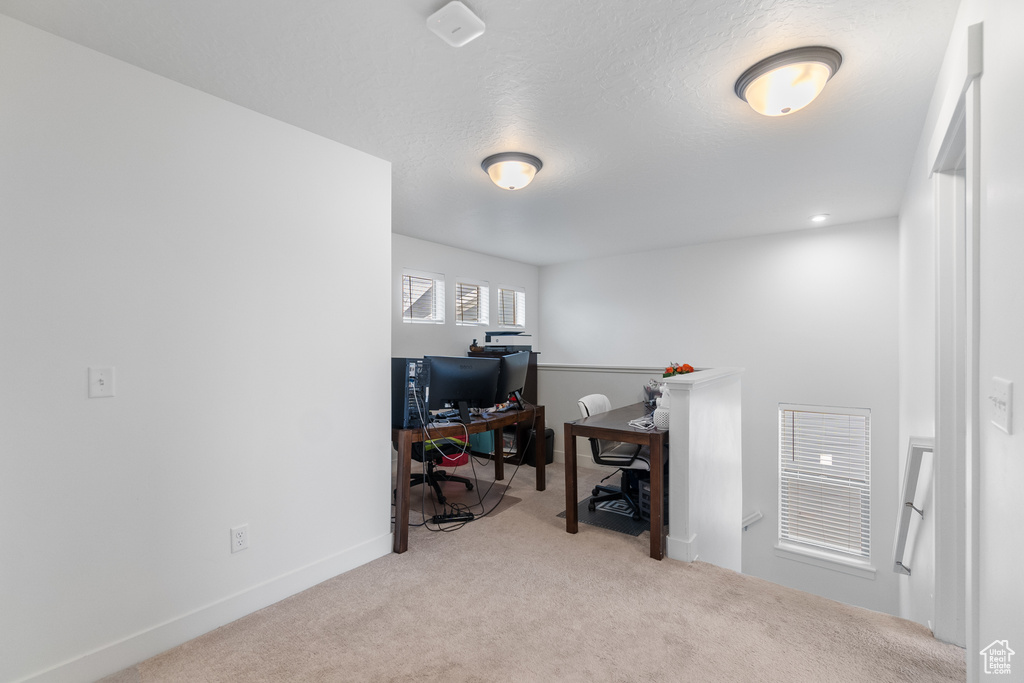 Carpeted office space featuring baseboards