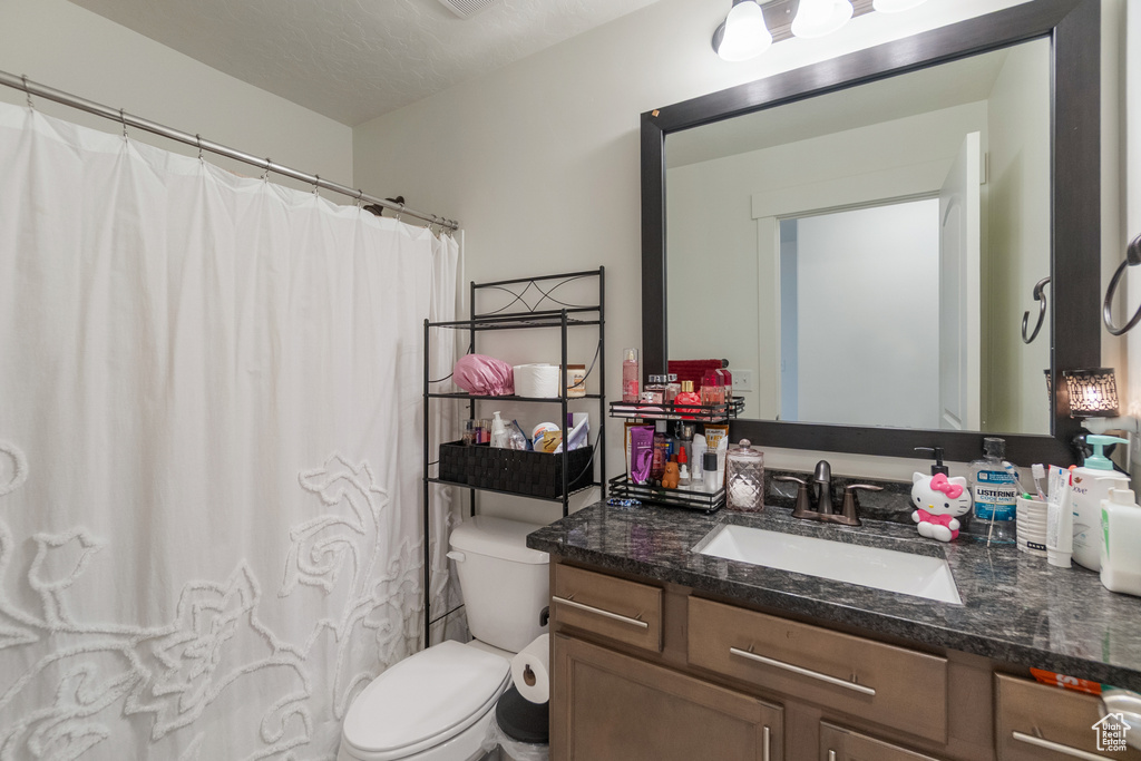 Full bathroom featuring vanity and curtained shower