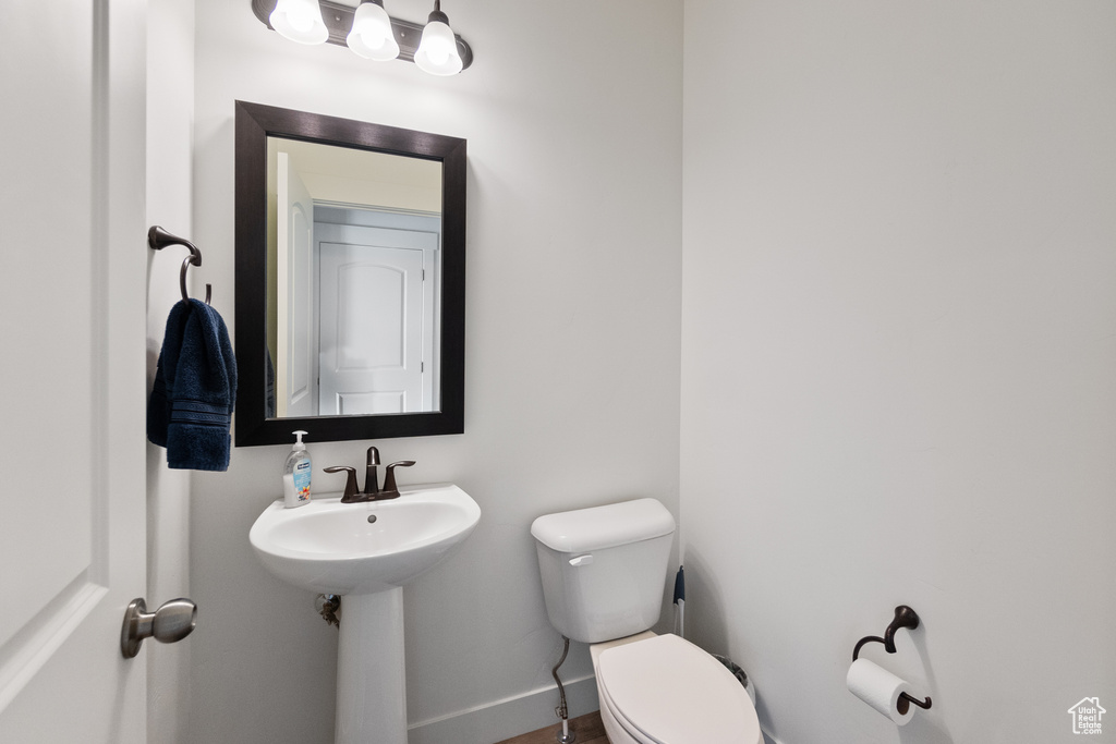 Bathroom with toilet and baseboards