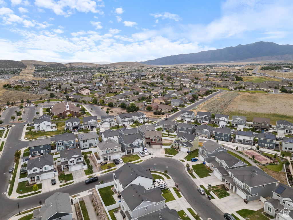 Aerial view of property and surrounding area with nearby suburban area and mountains