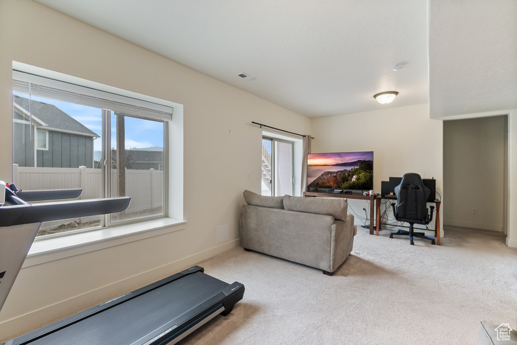 Workout room featuring carpet and baseboards
