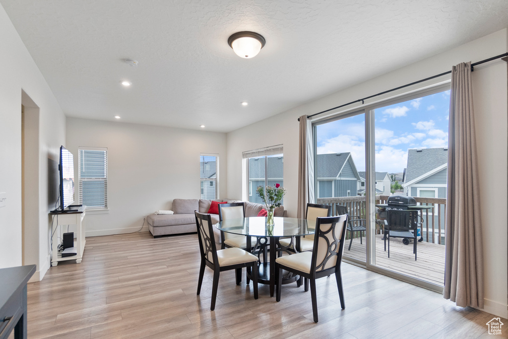 Dining space with light wood-type flooring and recessed lighting
