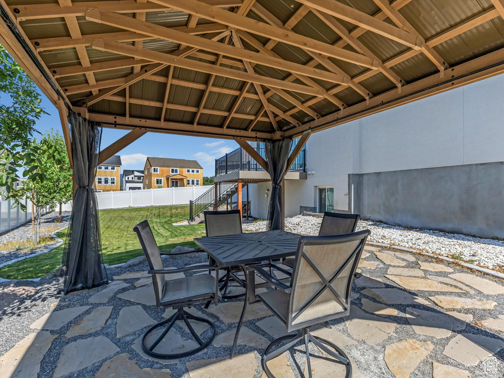 View of patio / terrace featuring outdoor dining space, a gazebo, and stairway