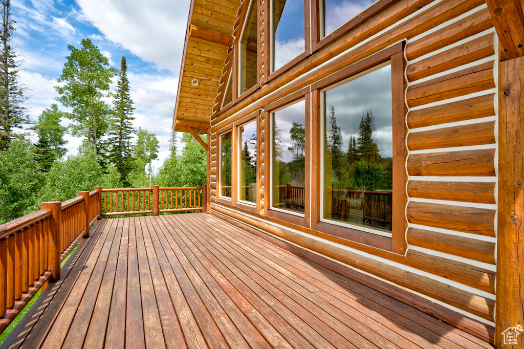 Wooden terrace featuring view of scattered trees