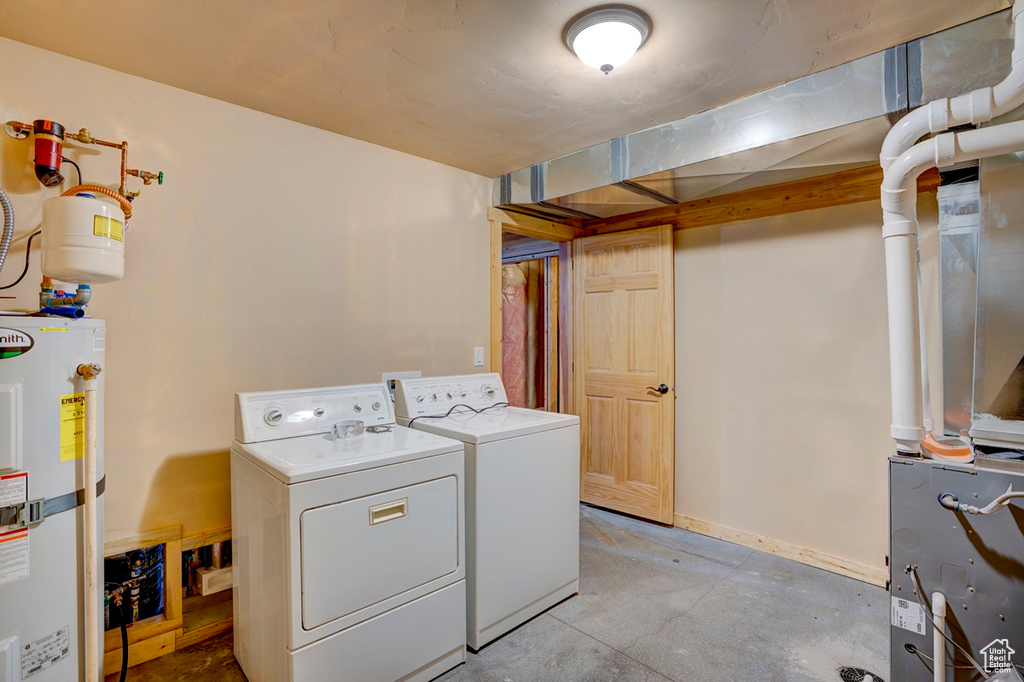 Washroom featuring secured water heater and washer and dryer