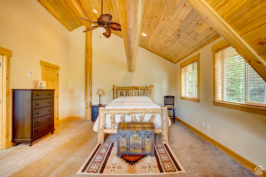 Carpeted bedroom with wooden ceiling and baseboards