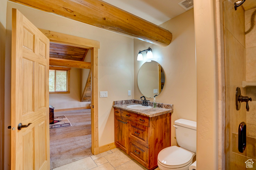 Bathroom featuring vanity and a shower