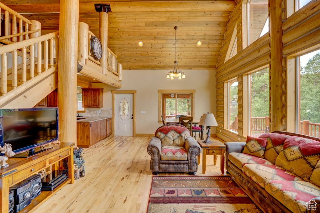 Living room featuring high vaulted ceiling, wood ceiling, a chandelier, light wood-style flooring, and recessed lighting